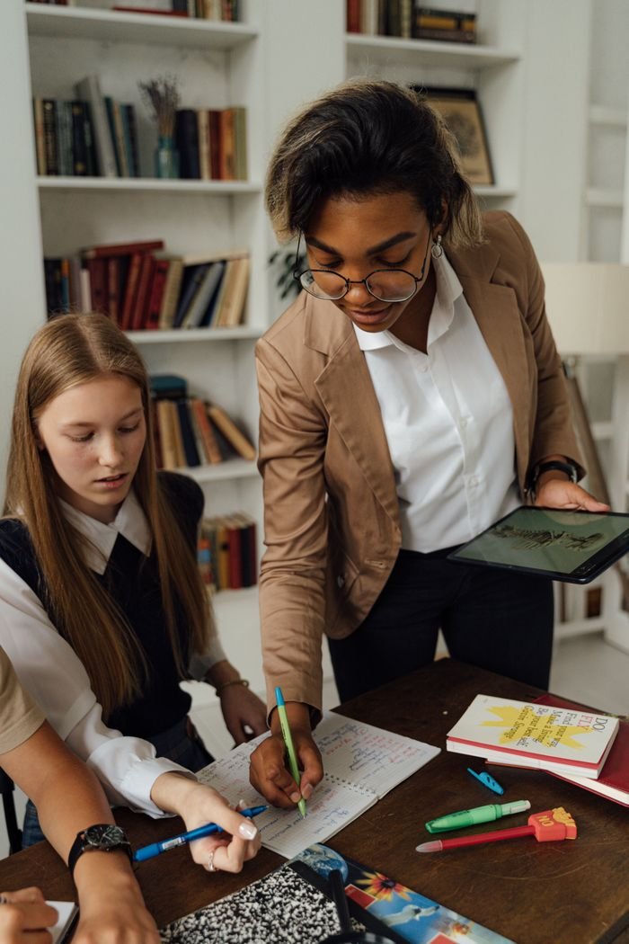 A teacher and students engaged in a collaborative learning activity in a classroom.
